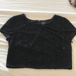 Detailed black top with beading all over.